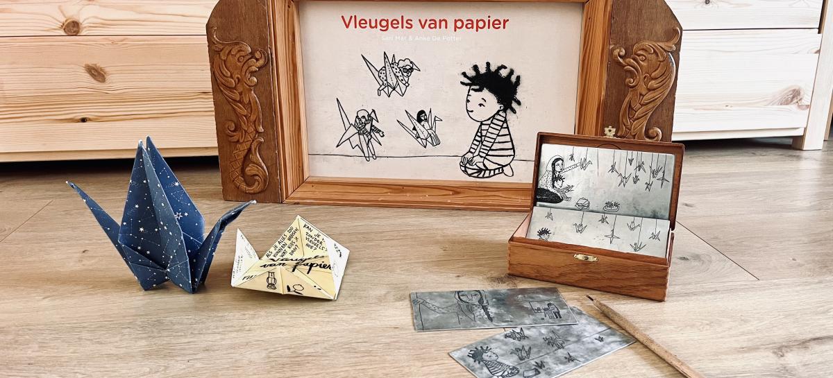 Materiaal om te tekenen en een origami vogel