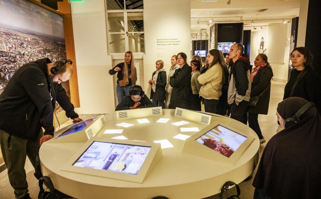 Foto van een groep mensen in een museumzaal