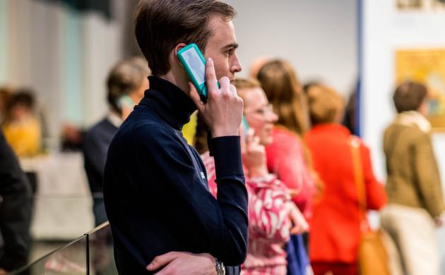 Persoon luistert naar een audiogids