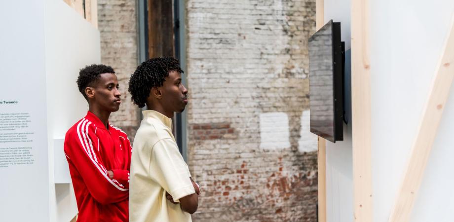 leerlingen volgen een rondleiding in de expo Vluchtverhalen