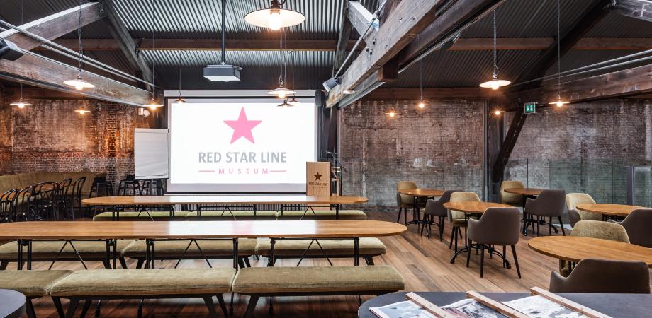 een mezzanine met presentatiescherm, banken en tafels